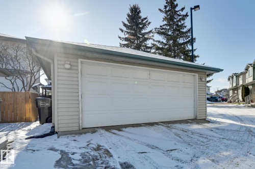 Snow covered garage featuring a detached garage - 59 14803 Miller Boulevard, Edmonton, AB - Outdoor With Exterior