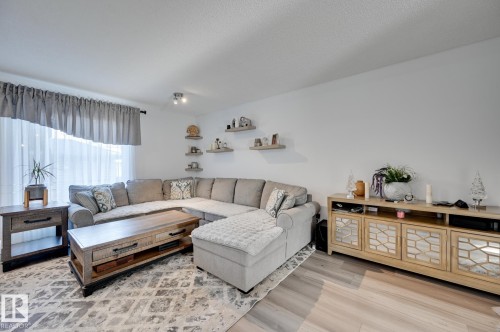 Living room with light wood-style flooring - 59 14803 Miller Boulevard, Edmonton, AB - Indoor Photo Showing Living Room