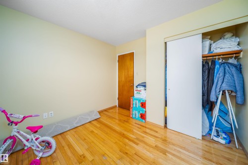 This room features hardwood floors and a closet with a sliding door - 7911 145 Avenue Nw, Edmonton, AB - Indoor