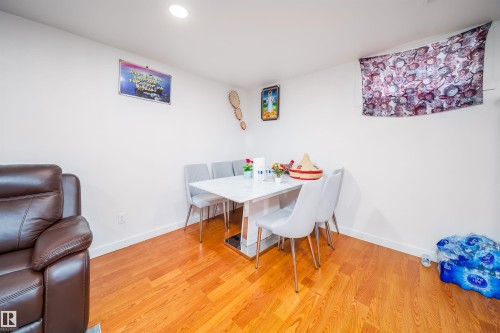The property features hardwood flooring, white walls, and recessed lighting - 7911 145 Avenue Nw, Edmonton, AB - Indoor Photo Showing Dining Room
