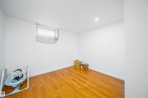 This room features hardwood flooring, white walls, and a recessed ceiling light - 7911 145 Avenue Nw, Edmonton, AB - Indoor Photo Showing Other Room
