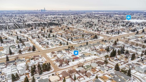 Aerial view of the surrounding residential area featuring a city skyline in the distance - 7911 145 Avenue Nw, Edmonton, AB - Outdoor With View