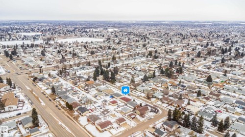 Aerial view of the property and its surrounding residential area, featuring a grid street pattern and numerous detached houses - 7911 145 Avenue Nw, Edmonton, AB - Outdoor With View