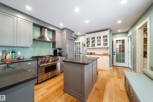 New cabinets with a Miele dishwasher and microwave.  Subzero fridge and Subzero wine fridge. Wolf 5 burner gas stove. - 8332 120 Street, Edmonton, AB - Indoor Photo Showing Kitchen With Upgraded Kitchen