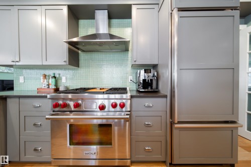 Wolf 5 burner gas stove, Sub Zero fridge and separate Sub Zero wine fridge - 8332 120 Street, Edmonton, AB - Indoor Photo Showing Kitchen