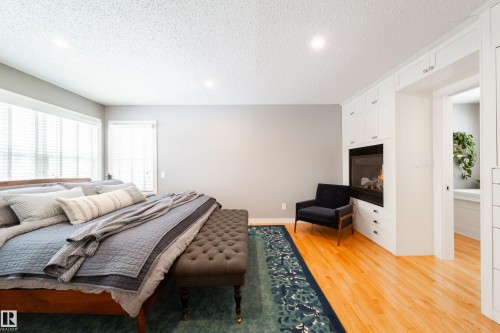 Primary bedroom with fireplace - 8332 120 Street, Edmonton, AB - Indoor Photo Showing Bedroom