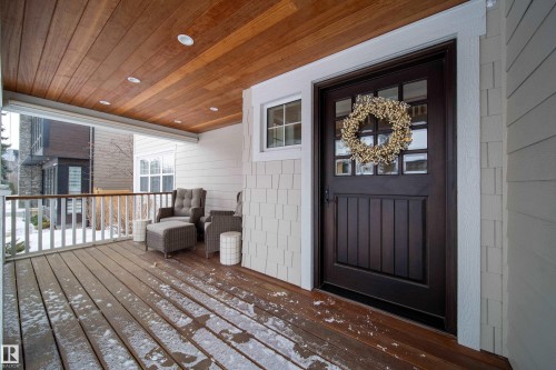 New 42" door , 2.25 " thick, with 5 pin locking system.  Spacious covered front veranda to enjoy your morning coffee. - 8332 120 Street, Edmonton, AB - Outdoor With Deck Patio Veranda With Exterior