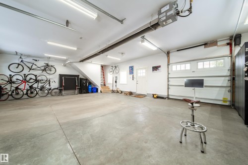 This over head door leads to backyard.  Garage has 5 inch thick concrete floors and 21 ft Sunstar Infrared gas heater - 8332 120 Street, Edmonton, AB - Indoor Photo Showing Garage