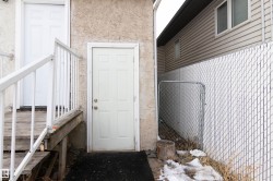 View of exterior entry with stucco siding - 