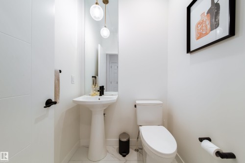 Half bath featuring toilet and light tile patterned floors - 19 Sturtz Place, Leduc, AB - Indoor Photo Showing Bathroom