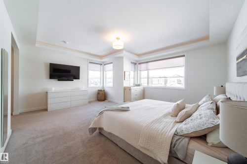 Carpeted bedroom featuring a tray ceiling - 19 Sturtz Place, Leduc, AB - Indoor Photo Showing Bedroom
