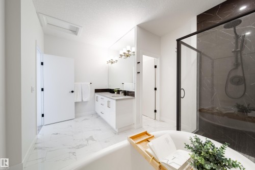 Full bathroom featuring vanity, a marble finish shower, light marble finish floors, a bath, and a textured ceiling - 19 Sturtz Place, Leduc, AB - Indoor Photo Showing Bathroom