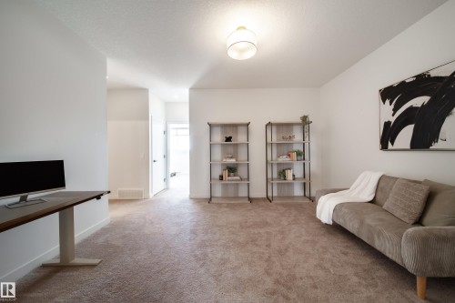 Living area with light carpet and baseboards - 19 Sturtz Place, Leduc, AB - Indoor