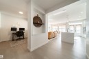 Hallway featuring an office area, light wood-style floors, and hanging lights - 19 Sturtz Place, Leduc, AB  - Indoor 