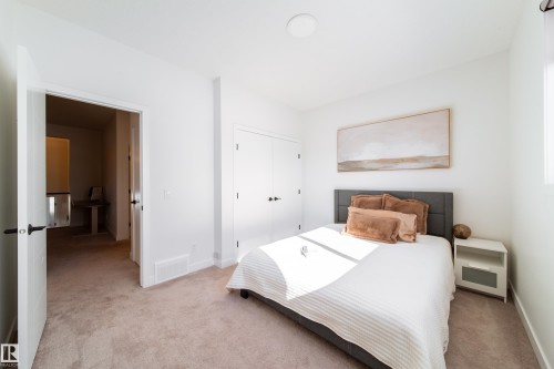 Bedroom with light colored carpet and a closet - 19 Sturtz Place, Leduc, AB - Indoor Photo Showing Bedroom