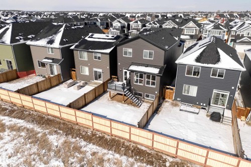 Snow covered rear of property with a residential view, a fenced backyard, and a deck - 19 Sturtz Place, Leduc, AB - Outdoor