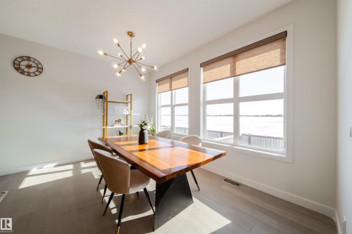Dining space with hanging lights and light wood-style flooring - 19 Sturtz Place, Leduc, AB - Indoor Photo Showing Dining Room