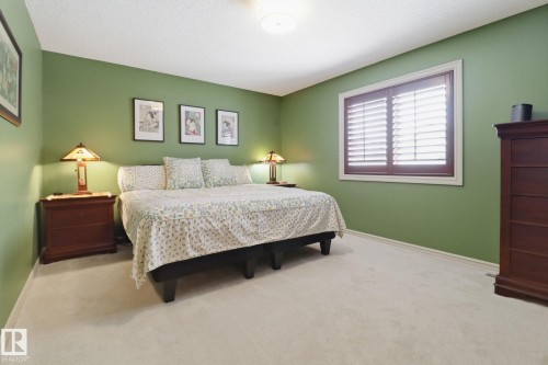 Bedroom featuring light colored carpet and a textured ceiling - 8311 11 Avenue, Edmonton, AB - Indoor Photo Showing Bedroom