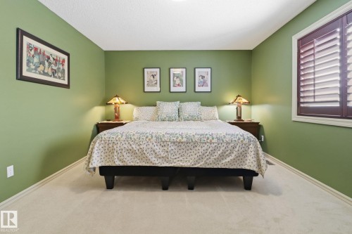 Carpeted bedroom featuring baseboards - 8311 11 Avenue, Edmonton, AB - Indoor Photo Showing Bedroom
