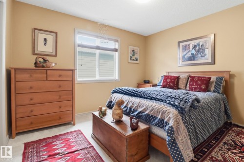 Bedroom with light carpet and baseboards - 8311 11 Avenue, Edmonton, AB - Indoor Photo Showing Bedroom