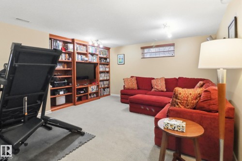 Living room featuring light colored carpet and rail lighting - 8311 11 Avenue, Edmonton, AB - Indoor