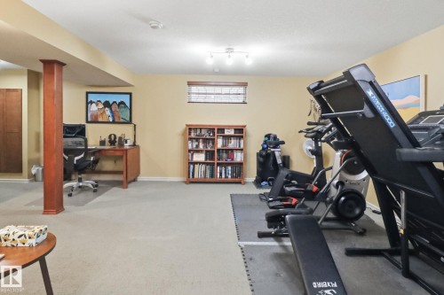 Exercise room featuring light carpet and baseboards - 8311 11 Avenue, Edmonton, AB - Indoor Photo Showing Gym Room