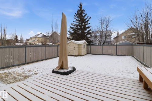 Snow covered deck with a shed, a fenced backyard, and a residential view - 8311 11 Avenue, Edmonton, AB - Outdoor