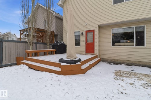 Snow covered property entrance featuring a deck - 8311 11 Avenue, Edmonton, AB - Outdoor With Deck Patio Veranda With Exterior