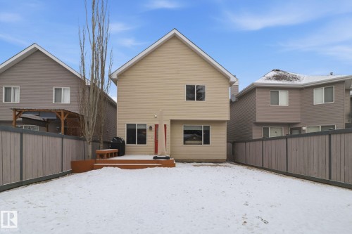 Snow covered house featuring a fenced backyard and a wooden deck - 8311 11 Avenue, Edmonton, AB - Outdoor