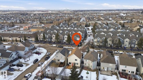 Aerial view of the neighborhood featuring residential properties with varying architectural styles, dark pitched roofs, and visible backyards - 8311 11 Avenue, Edmonton, AB - Outdoor With View