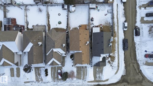 Aerial view of properties featuring pitched roofs, private driveways, and snow-covered yards - 8311 11 Avenue, Edmonton, AB - Outdoor