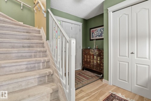 Foyer entrance featuring a textured ceiling and light wood-style flooring - 8311 11 Avenue, Edmonton, AB - Indoor Photo Showing Other Room