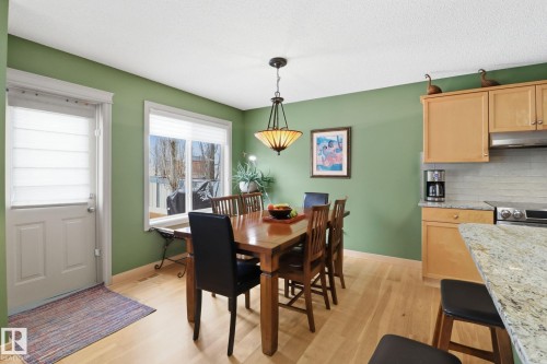 Dining area featuring light wood-style flooring and baseboards - 8311 11 Avenue, Edmonton, AB - Indoor Photo Showing Dining Room