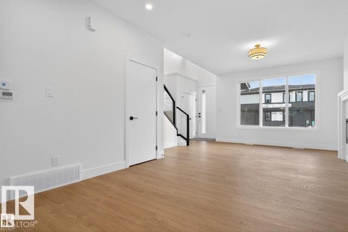 Unfurnished living room featuring light wood-type flooring and baseboards - 45 Rosa Crescent, St. Albert, AB - Indoor Photo Showing Other Room
