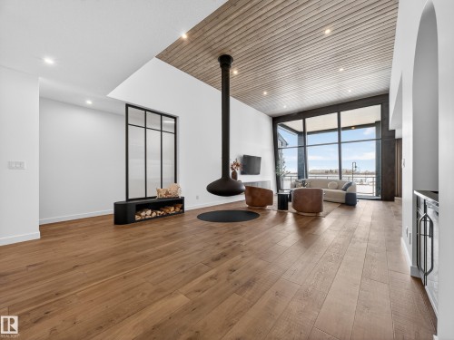 Living room featuring hardwood / wood-style flooring, recessed lighting, and expansive windows - 7104 54 Avenue, Beaumont, AB - Indoor Photo Showing Other Room