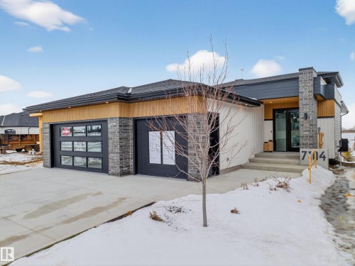 Contemporary home featuring an attached garage and concrete driveway - 7104 54 Avenue, Beaumont, AB - Outdoor