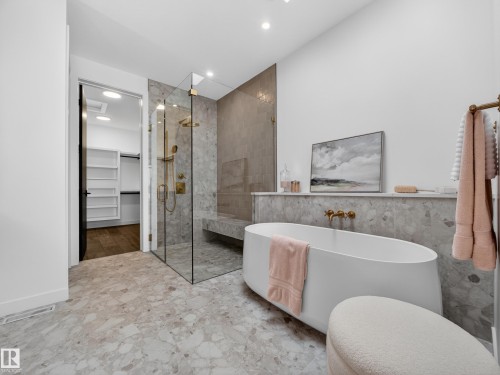 Bathroom featuring a spacious closet, a freestanding bath, a shower stall, recessed lighting, and tile walls - 7104 54 Avenue, Beaumont, AB - Indoor Photo Showing Bathroom