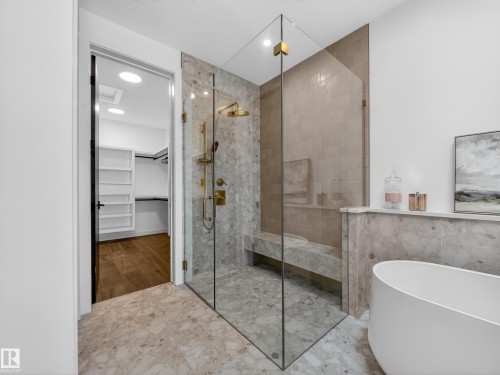 Full bathroom featuring a spacious closet, a freestanding tub, a shower stall, and recessed lighting - 7104 54 Avenue, Beaumont, AB - Indoor Photo Showing Bathroom