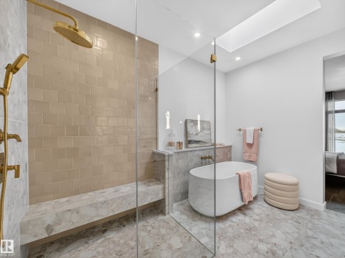 Bathroom with ensuite bathroom, a soaking tub, walk in shower, a skylight, and recessed lighting - 7104 54 Avenue, Beaumont, AB - Indoor Photo Showing Bathroom