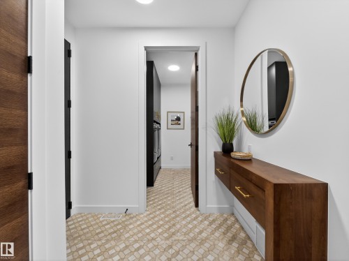 Corridor with baseboards and light flooring - 7104 54 Avenue, Beaumont, AB - Indoor Photo Showing Other Room