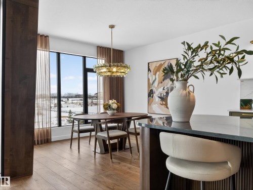 Dining space featuring light wood-style floors and hanging lights - 7104 54 Avenue, Beaumont, AB - Indoor Photo Showing Dining Room