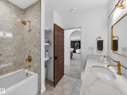 Full bathroom with vanity, shower / bath combination, and light marble finish floors - 7104 54 Avenue, Beaumont, AB - Indoor Photo Showing Bathroom