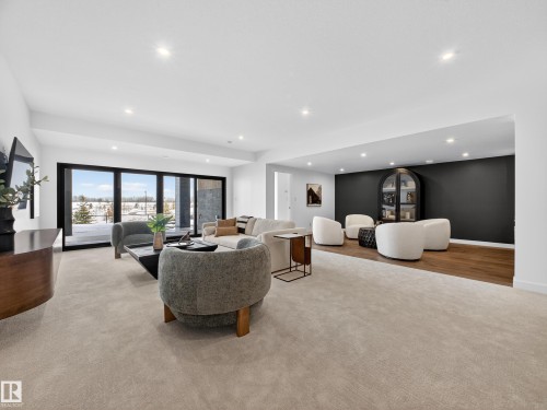 Living room featuring light carpet and recessed lighting - 7104 54 Avenue, Beaumont, AB - Indoor
