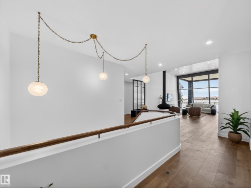 Hallway featuring dark wood-style flooring, recessed lighting, and expansive windows - 7104 54 Avenue, Beaumont, AB - Indoor Photo Showing Other Room