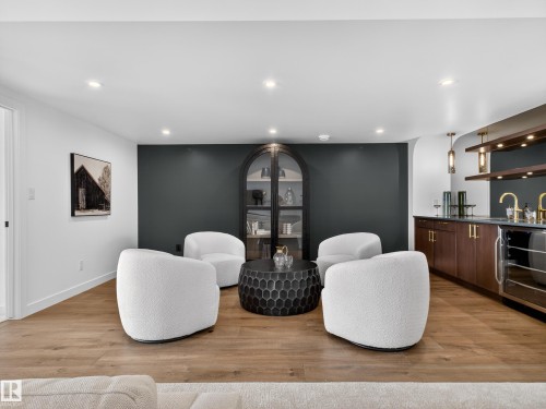 Living area with light wood-type flooring, recessed lighting, wet bar, and wine cooler - 7104 54 Avenue, Beaumont, AB - Indoor