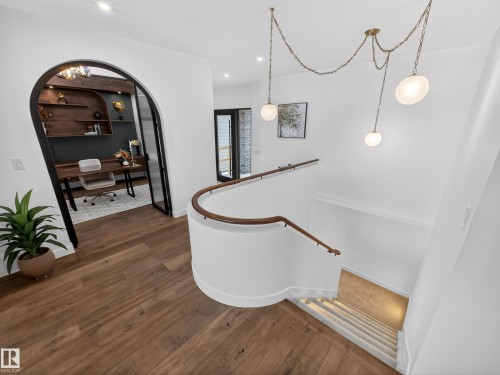 Stairway with hardwood / wood-style floors, arched walkways, and recessed lighting - 7104 54 Avenue, Beaumont, AB - Indoor Photo Showing Other Room