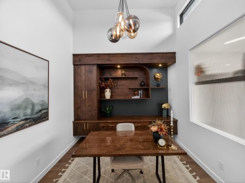 Office with dark wood-type flooring and hanging lights - 7104 54 Avenue, Beaumont, AB - Indoor Photo Showing Other Room