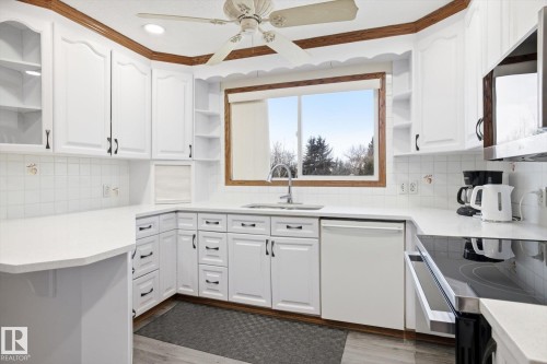 Kitchen with dishwasher, stainless steel microwave, and white cabinetry - 83 Bellevue Crescent, St. Albert, AB - Indoor Photo Showing Kitchen