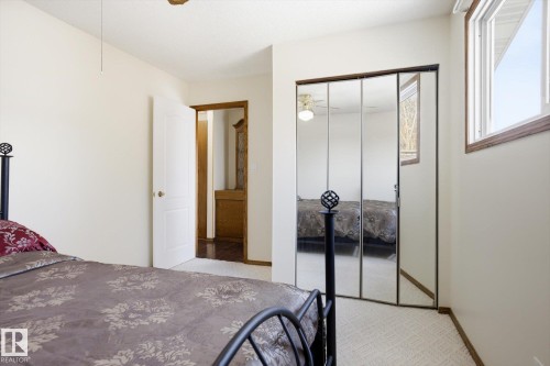Bedroom with light carpet, a closet, and a ceiling fan - 83 Bellevue Crescent, St. Albert, AB - Indoor Photo Showing Bedroom