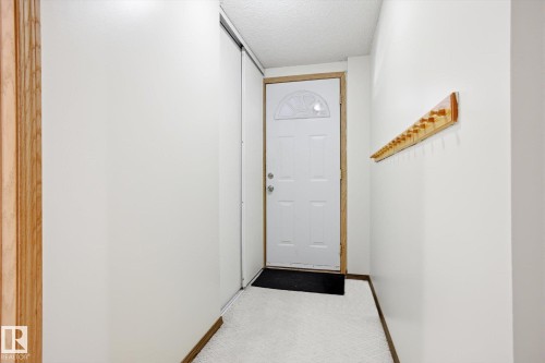 Doorway featuring a textured ceiling and carpet - 83 Bellevue Crescent, St. Albert, AB - Indoor Photo Showing Other Room
